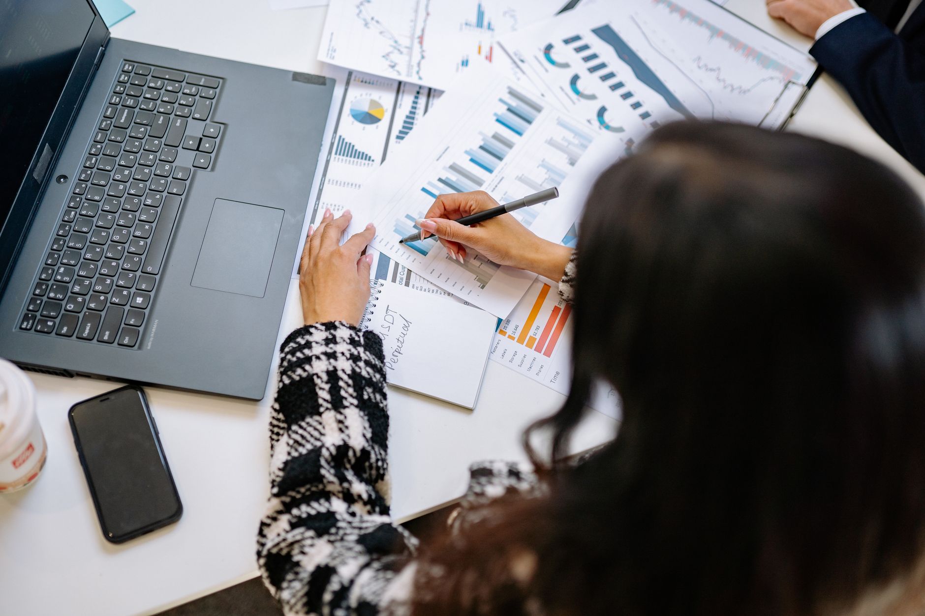 Finance director analysing climate-related financial disclosures data on screen