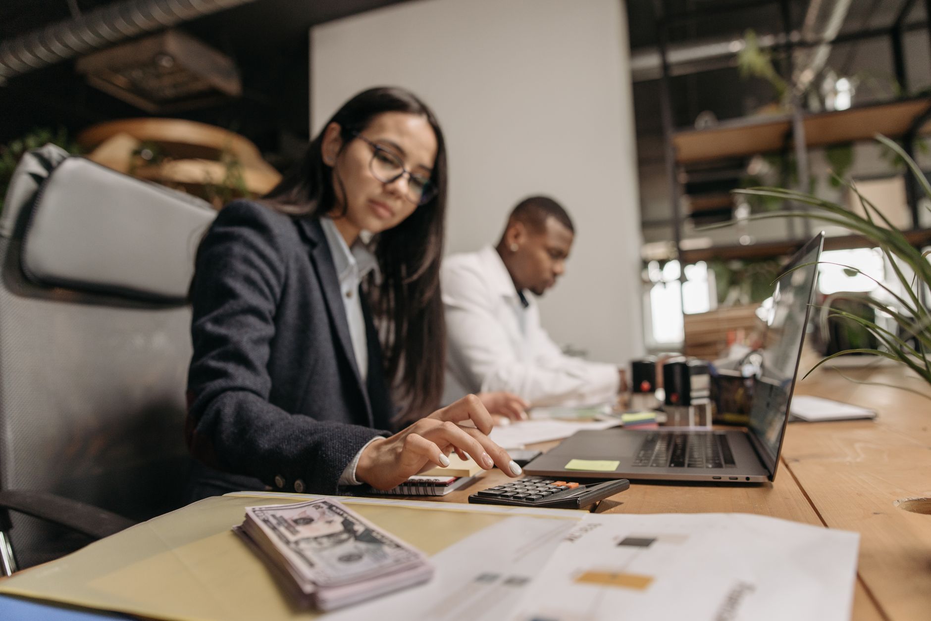Accountant using cloud-native ERP software on a laptop for UK small business finance